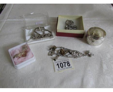 A silver charm bracelet, napkin rings, watch chain, St. Christopher etc