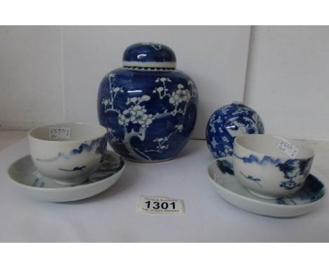 An oriental blue and white ginger jar, small pot and 2 tea cups and saucers