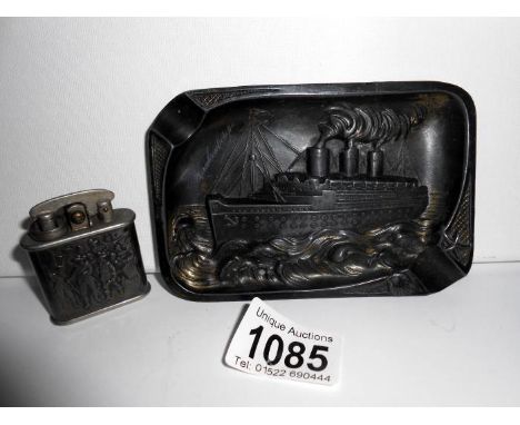 A cast metal 'Queen Mary' liner ashtray, signed and a rare Colibri lighter