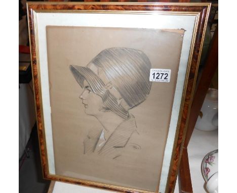 A framed and glazed pencil portrait of a lady