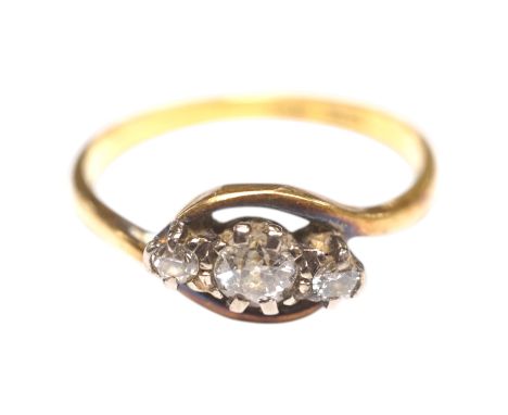 An 18ct, plat and three stone diamond set crossover ring, size Q/R, gross weight 3 grams. Condition - fair