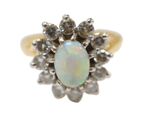 A modern 18ct gold, white opal and diamond set oval cluster ring, size M/N, gross weight 4.6 grams, the opal weighing approxi