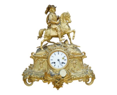 A late 19th century French ormolu mantel clock surmounted with a cavalier on horseback, key and pendulum, 38cm. Condition - f