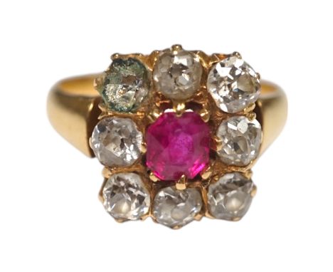An early 20th century yellow metal, single stone ruby and eight stone diamond set square cluster ring, size O, gross weight 5