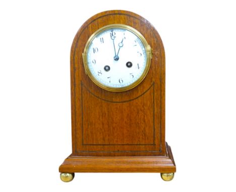 A cased brass carriage timepiece and a dome topped Edwardian mantel clock striking on a coiled gong, backplate stamped BTG, 2