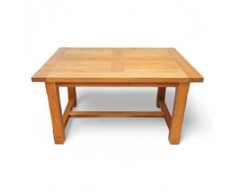 Light oak extending dining table, rectangular top with two additional leaves, on square chamfered supports united by H-stretc