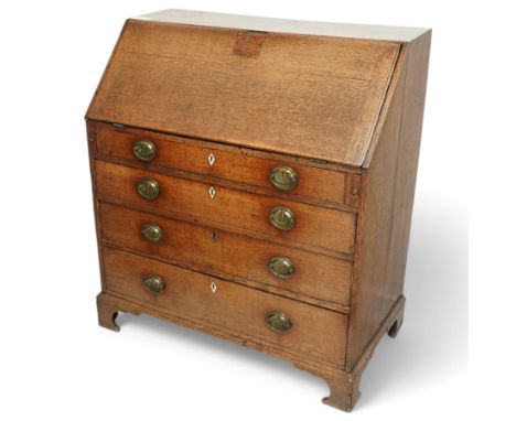 George III oak bureau, fall front enclosing fitted interior, four graduating drawers below, on bracket feet Dimensions: Heigh
