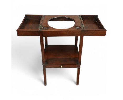 George III mahogany washstand, the hinged lid inlaid with figured oval panels within geometric bands, the interior fitted wit
