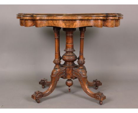 A mid-Victorian burr walnut fold-over card table with boxwood inlay, the top hinged to reveal a surface inset with baize, on 