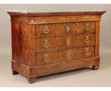 A 19th century French Empire style figured mahogany commode with grey marble top above four oak-lined drawers, on demi-lune f