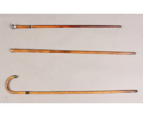 A Victorian Malacca swordstick with later fitted banded aluminium handle, length 82cm, together with two other walking canes,