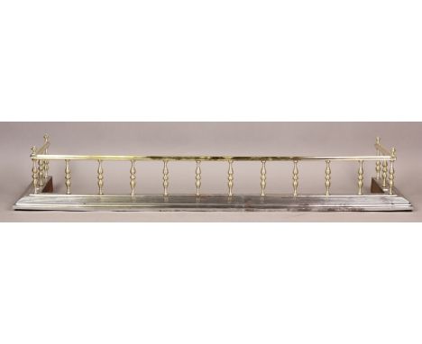 A 19th century brass and steel fender, the top rail and stepped steel curb united by knopped brass pillared supports, height 