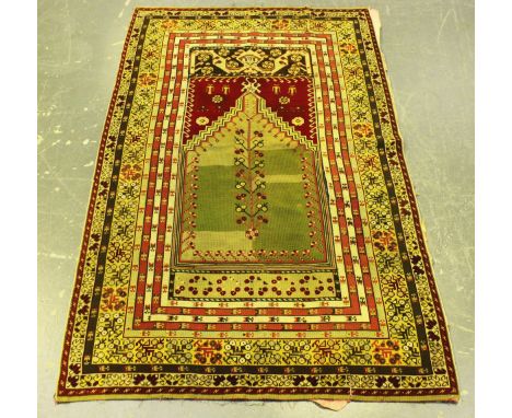 A 19th century needlework tapestry copy of a Turkish prayer rug, worked in overall coloured wools, 176cm x 108cm.Buyer’s Prem