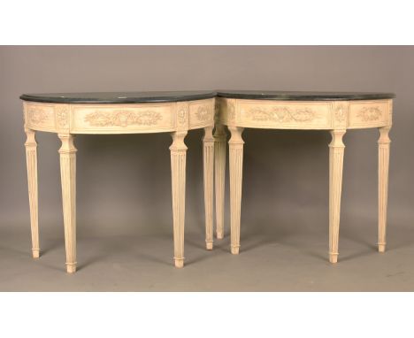 A pair of late 20th century George III style cream painted demi-lune console tables with grey tops, the friezes decorated wit