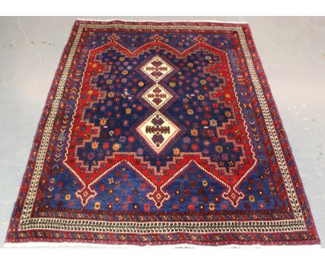 An Afshar rug, South-west Persia, late 20th century, the ink blue field with three hooked medallions, supported by star motif