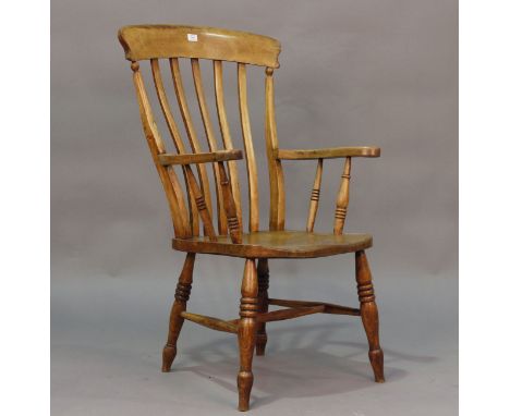 A 19th century ash and elm Windsor armchair with comb back and shaped seat, height 109cm, width 63cm.Buyer’s Premium 29.4% (i