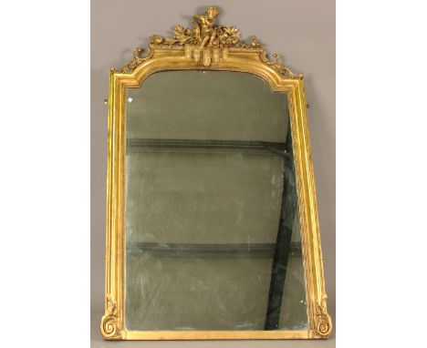 An impressive mid-Victorian giltwood and gesso overmantel mirror, the break arch top with a surmount of a central putto playi