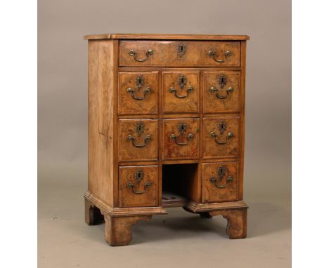 A George I style burr walnut and crossbanded chest, fitted with an arrangement of nine drawers, on bracket feet, height 75cm,