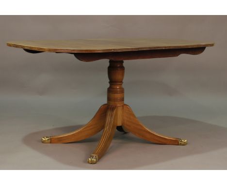 A 19th century mahogany rectangular tip-top breakfast table, raised on a turned stem and sabre legs, height 74cm, length 141c