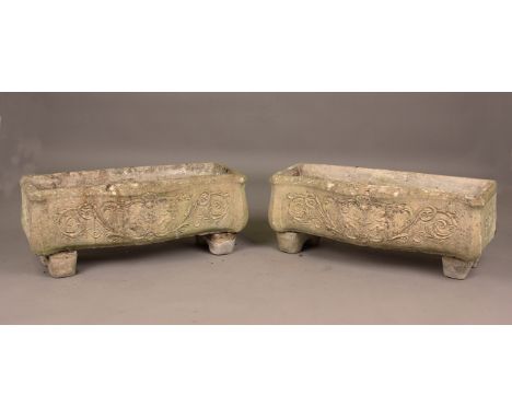 A pair of 20th century cast composition stone trough planters, the serpentine fronts moulded with cherubs and scrolls, height