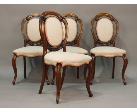 A set of four mid-Victorian rosewood framed spoon back dining chairs, finely carved with foliate scrolls, height 90cm, width 