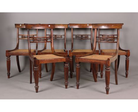 A set of six William IV rosewood bar back dining chairs, the centre rails with carved stiff leaf sprays above cane seats, on 