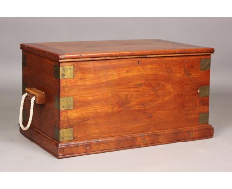 An early 20th century teak and brass bound seaman's trunk, the hinged lid enclosing a removable false base panel, height 43cm