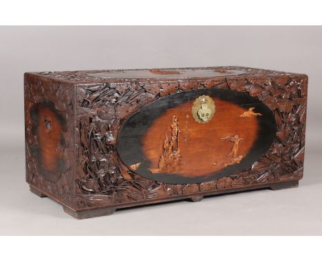 An early/mid-20th century Chinese carved and stained camphor trunk, decorated with overall figures and foliage, height 57cm, 