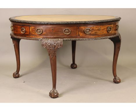 An early 20th century George III style mahogany circular drum table, bearing maker's stamp 'Phillips Bristol', the top inset 