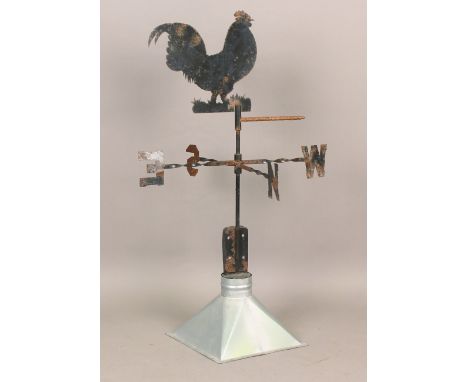 A 20th century sheet metal weather vane in the form of a chicken, mounted on an aluminium dome, total height 103cm.Buyer’s Pr