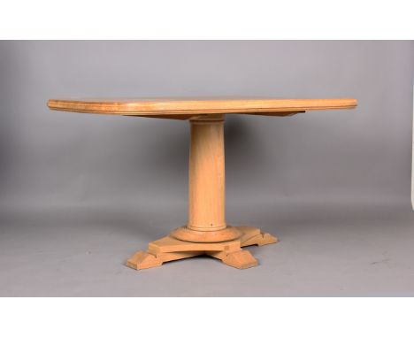 A modern oak centre table by Mark Wilkinson, raised on a quatrefoil base with scroll feet, height 77cm, length 130cm, depth 9