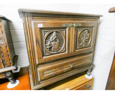 A Breton dwarf oak sideboard with figure carved door panels and one drawer under 2'6 wide 