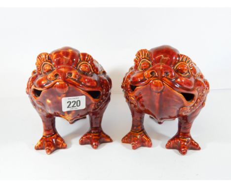A pair of Burmantoft 19th Century grotesque animal form jardiniere's in a red glaze modelled as  stylized toad lions with thr