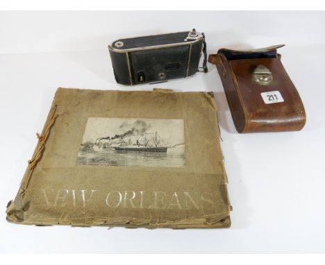 An old box camera and a souvenir book of New Orleans 