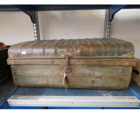 A small old partly rusted metal trunk 