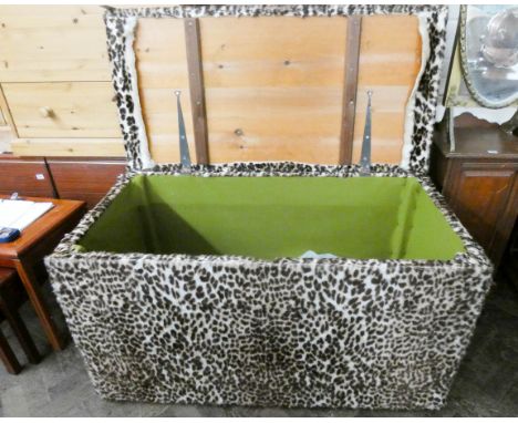 A large leopard skin material covered trunk 