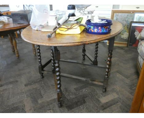 An oval oak gate legged dining table on barley twist legs, 3'6 wide 