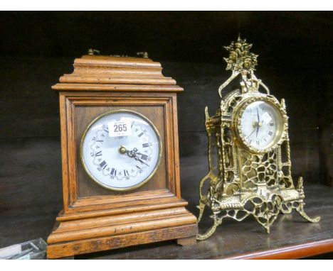 A decorative brass mantel clock and an oak cased vintage style clock 