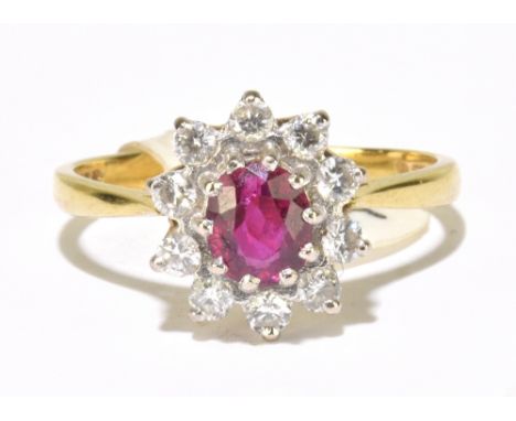 An 18ct yellow gold diamond and ruby oval floral cluster ring, with oval ruby within a border of ten brilliant cut diamonds, 