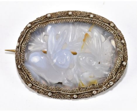 A silver and oval carved lilac jade Chinese brooch, the pierced plaque depicting two rabbits, stamped 'Silver, China', 35 x 2