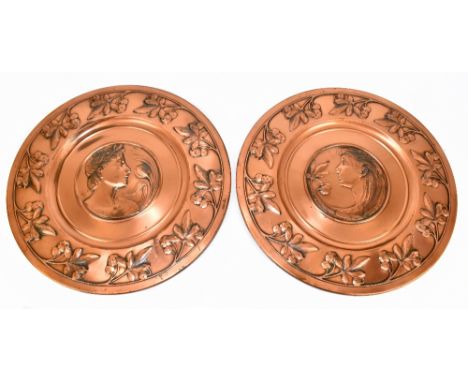 WMF; a pair of copper circular chargers, embossed to the centre, with portrait representing a Greek male beside floral decora