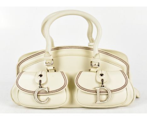 CHRISTIAN DIOR; a 2005 vintage white leather 'My Dior' handbag with large C and D bag charms to front, two top handles, zip t