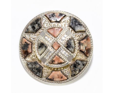 ATTRIBUTED TO HAMILTON RETTIE; a late Victorian white metal Scottish circular brooch, set with Rubislaw and Alford polished g