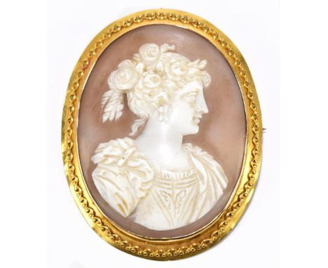 A 9ct yellow gold cased well carved cameo brooch depicting the profile portrait of a young woman, with patterned gallery and 