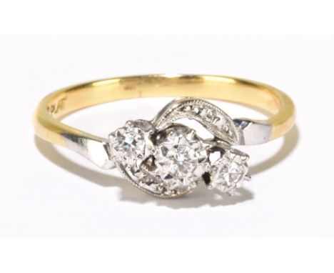 An 18ct yellow gold three stone diamond illusion set swept ring, size R, approx 2.95g.Additional InformationMinor surface wea