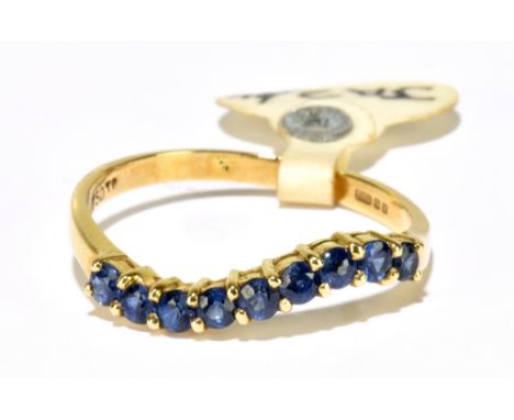 An 18ct yellow gold sapphire wavy half eternity ring, approx. 2.1g.Additional InformationGeneral surface abrasions to the sap