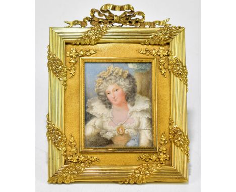 A late 19th/early 20th century miniature on ivory portrait of a lady in a pearl trimmed white dress, unsigned, in elaborate g