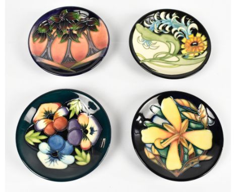 MOORCROFT; four modern ceramic pin dishes, various patterns including 'New Forest' and 'Parade', diameter 12cm, each boxed.&n