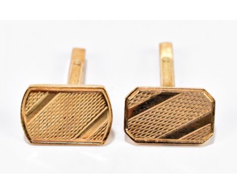 A pair of 9ct yellow gold cufflinks with engraved detail to the rectangular platforms, approximately 9.7g.&nbsp;Additional In