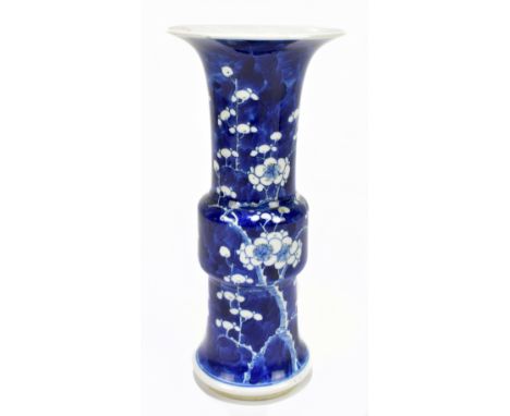 A 19th century Chinese blue and white porcelain gu vase decorated with prunus flowers, bears Kangxi four character mark to ba